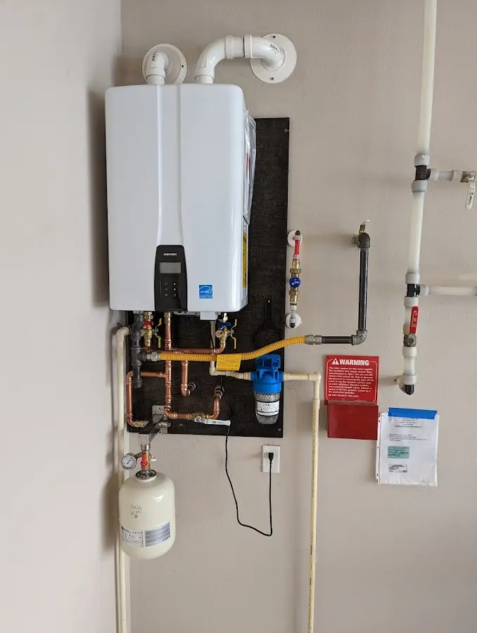 Professional plumber installing copper piping in a Santa Fe home